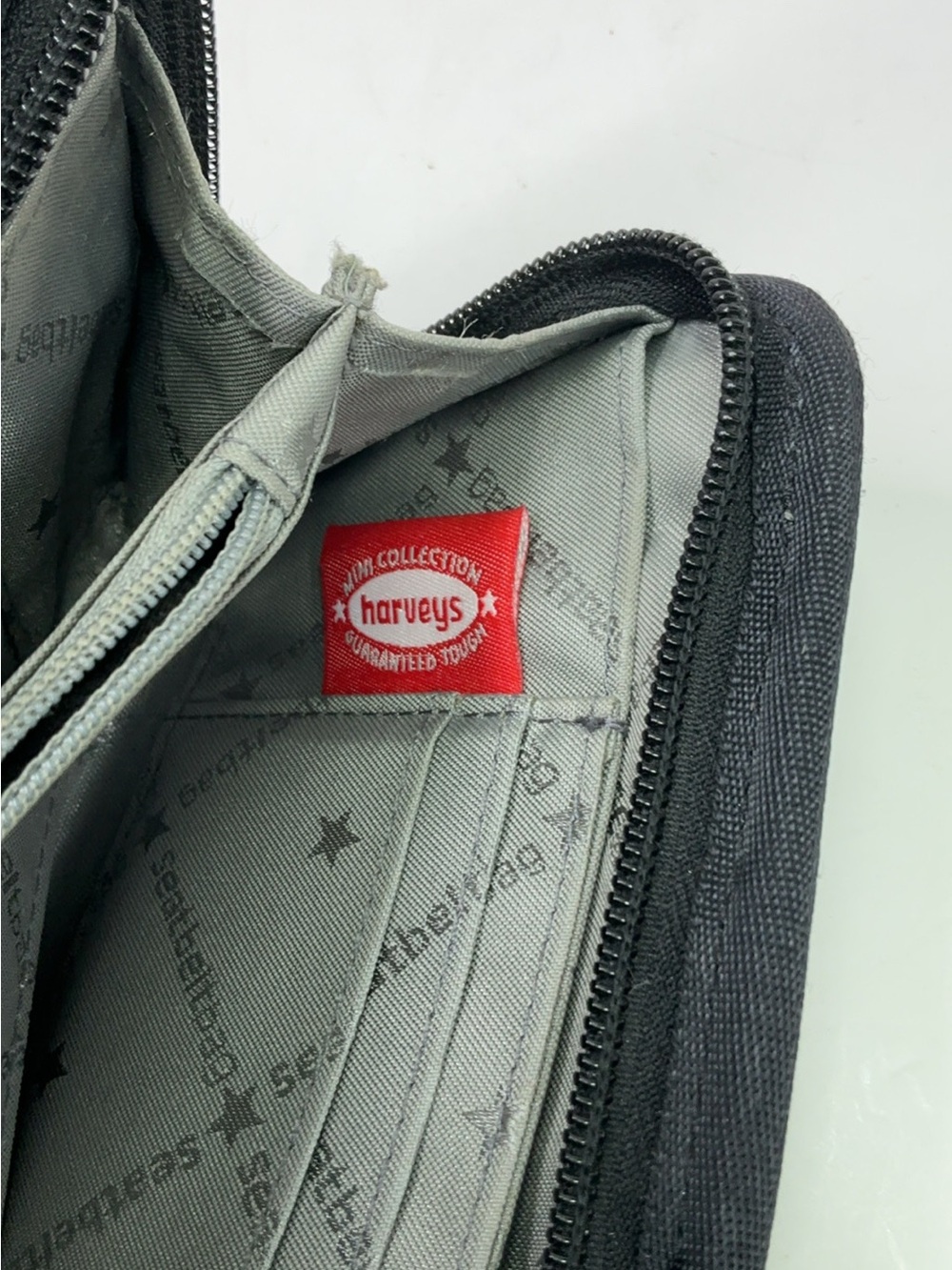 Harveys Seatbelt Bag wallet features black woven webbing and a gray. - Picture 10 of 11